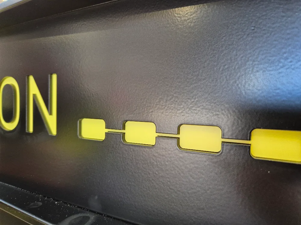 Cut lettering and stud detail, RAL 9005.